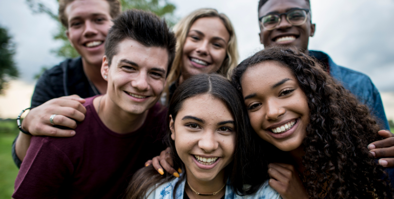 a group of diverse teens smiling